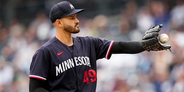 Minnesota Twins starting pitcher Pablo Lopez, #49, receives the ball in the first inning of a baseball game against the New York Yankees, Sunday, April 16, 2023, in New York.