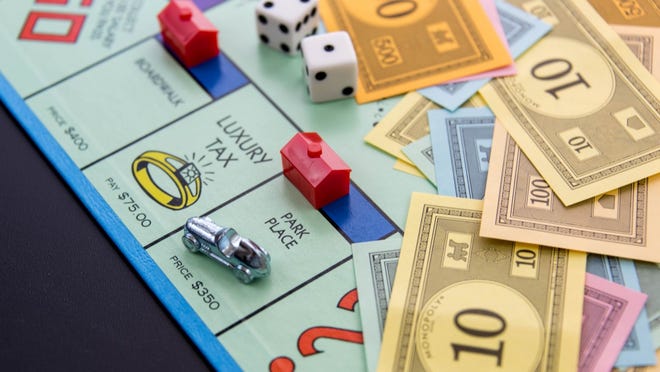 Players use money to buy properties, pay taxes and collect funds from the bank in Monopoly.