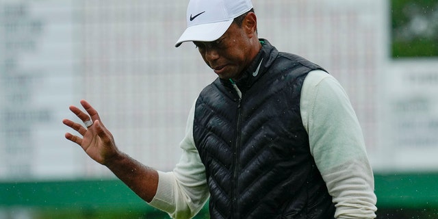 Tiger Woods waves to Augusta National crowd during the Masters golf tournament