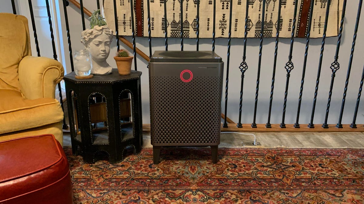 The large Coway Airmega 400 air purifier in a living room next to a side table.