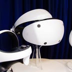 Sony PlayStation VR 2 virtual reality headset and controllers on stands