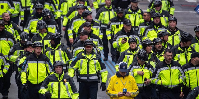 Police officers walk near the finish line during the 127th Boston Marathon in Boston, Massachusetts on April 17, 2023. - 30,239 people are entered to run the 26.2 mile (42.2K) race from a total of 106 countries and all 50 US states.  This year also is the 10 year anniversary of the 2013 bombings. 