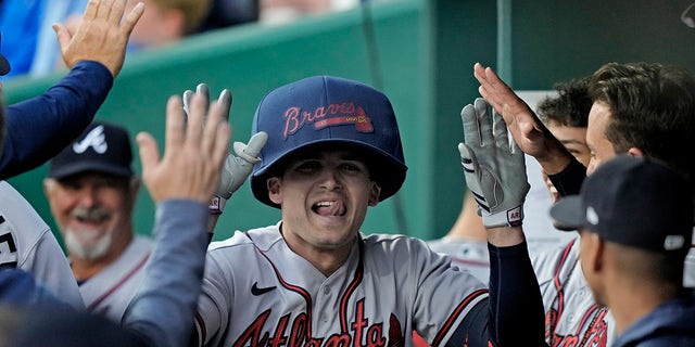 Atlanta Braves' Austin Riley celebrates in the dugout after hitting a solo home run during the first inning against the Royals Friday, April 14, 2023, in Kansas City, Missouri.