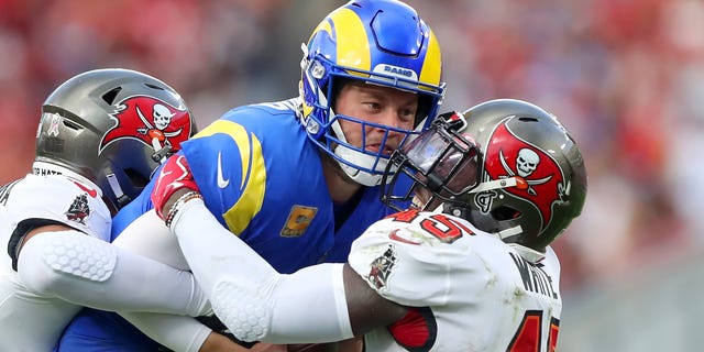 Los Angeles Rams quarterback Matthew Stafford (9) is wrapped up by Tampa Bay Buccaneers linebacker Devin White (45) during the regular season game between the Los Angeles Rams and the Tampa Bay Buccaneers on November 06, 2022 at Raymond James Stadium in Tampa, Florida.