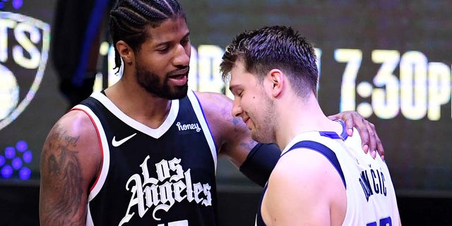 Paul George #13 of the LA Clippers consoles Luka Doncic #77 of the Dallas Mavericks after defeating the Dallas Mavericks 126-111 during game seven of the Western Conference First Round NBA Playoff basketball game at the Staples Center in Los Angeles on Sunday, June 6, 2021. LA Clippers won 126-111 to advance to the second round.