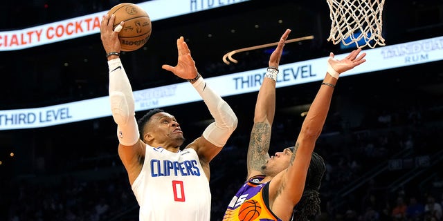 Los Angeles Clippers guard Russell Westbrook, #0, drives on Phoenix Suns guard Damion Lee during the second half of an NBA basketball game, Sunday, April 9, 2023, in Phoenix.