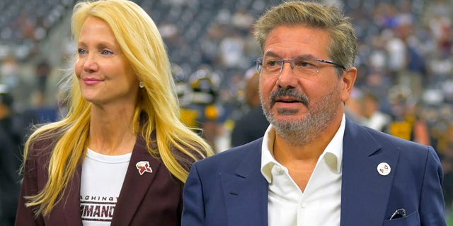 Washington Commanders owners Tanya Snyder and Dan Snyder on the field before the Dallas Cowboys game at AT&amp;T Stadium on Oct. 2, 2022, in Arlington, Texas.