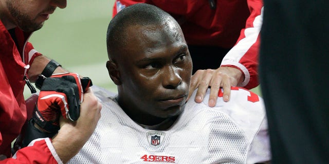 FILE - San Francisco 49ers cornerback Phillip Adams (35) is attended to after injuring his left leg during the third quarter of an NFL football game against the St. Louis Rams on Dec. 26, 2010, in St. Louis.