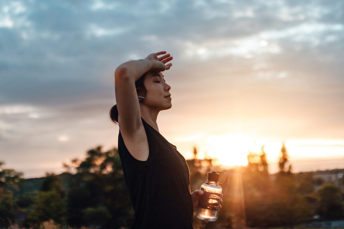 Woman drinking water after exercise