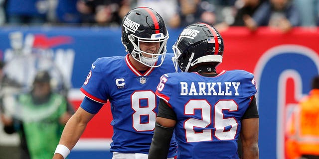 Daniel Jones (8) and Saquon Barkley (26) of the New York Giants in action against the Chicago Bears at MetLife Stadium Oct. 2, 2022, in East Rutherford, N.J. 