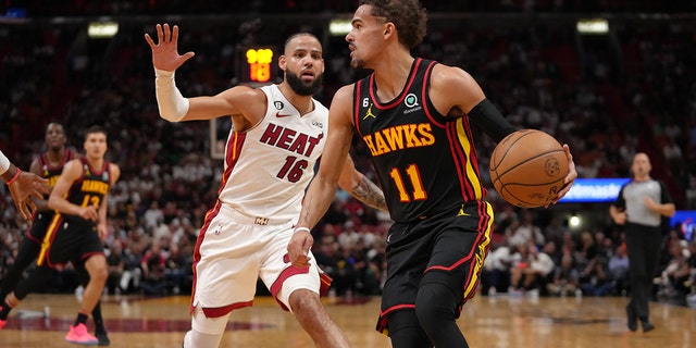 Trae Young #11 of the Atlanta Hawks handles the ball during the 2023 Play-In Tournament against the Miami Heat on April 11, 2023, at Kaseya Center in Miami, Florida. 