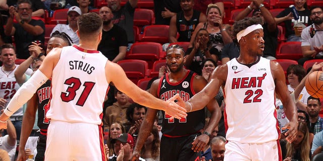 Max Strus and Jimmy Butler (22) of the Miami Heat high-five during a game against the Chicago Bulls during the 2023 play-in tournament April 14, 2023, at the Kaseya Center in Miami, Fla. 