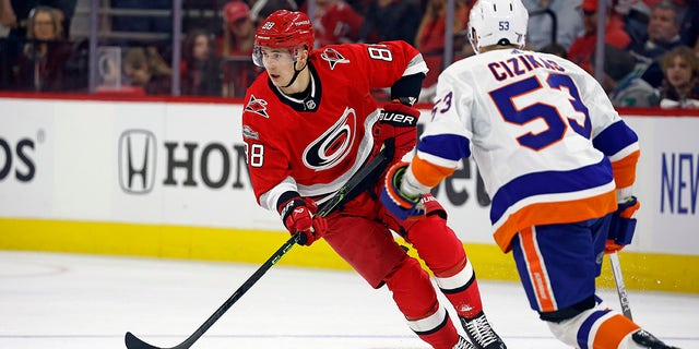 Carolina Hurricanes' Martin Necas (88) skates with the puck around New York Islanders' Casey Cizikas (53) during the second period of Game 1 of an NHL hockey Stanley Cup first-round playoff series in Raleigh, N.C., Monday, April 17, 2023. 