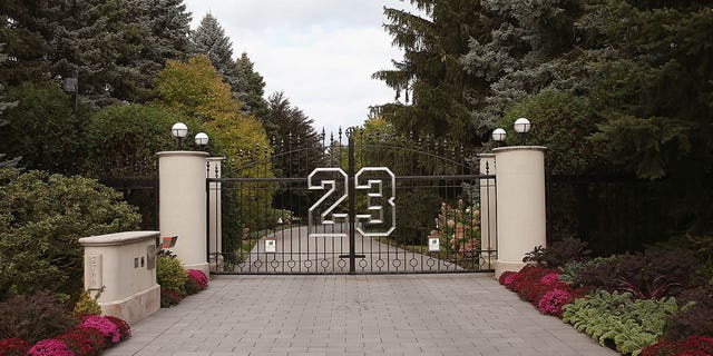 A gate with the No. 23 controls access to the home of basketball legend Michael Jordan Oct. 21, 2013, in Highland Park, Ill.