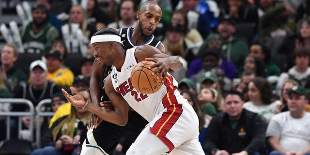 Miami Heat forward Jimmy Butler, #22, drives against Milwaukee Bucks forward Khris Middleton, #22, in the second half during game one of the 2023 NBA Playoffs at Fiserv Forum in Milwaukee April 16, 2023.