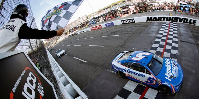 Kyle Larson, driver of the #5 HendrickCars.com Chevrolet, takes the checkered flag to win the NASCAR Cup Series NOCO 400 at Martinsville Speedway on April 16, 2023 in Martinsville, Virginia.