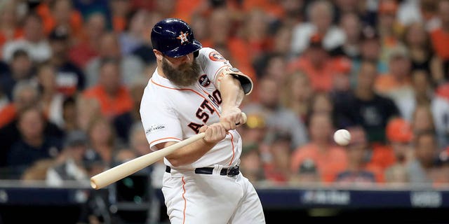 Evan Gattis #11 of the Houston Astros hits a a solo home run against CC Sabathia #52 of the New York Yankees during the fourth inning in Game Seven of the American League Championship Series at Minute Maid Park on October 21, 2017 in Houston, Texas.