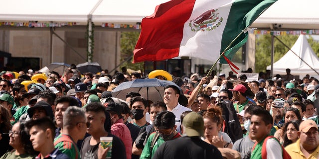 Football fans attend the FIFA Fan Fest event at the Revolution Monument to support the Mexican team in their match against Saudi Arabia during the FIFA World Cup Qatar 2022. On Nov. 30, 2022 in Mexico City.