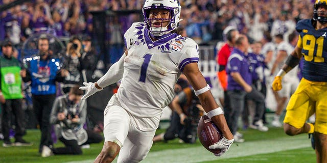 TCU Horned Frogs wide receiver Quentin Johnston scores a touchdown against the Michigan Wolverines during the Vrbo Fiesta Bowl at State Farm Stadium in Glendale, Arizona, on Dec. 31, 2022.