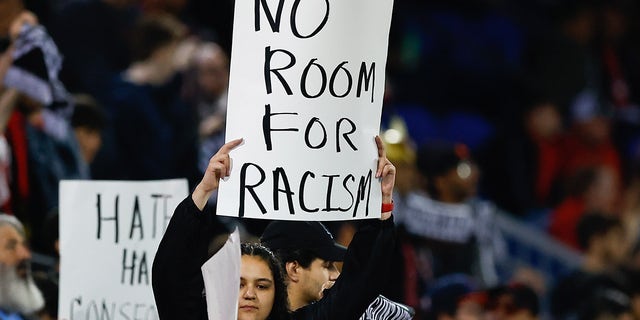 New York Red Bulls supporters hold up signs prior to the Major League Soccer game against the Houston Dynamo on April 15, 2023, at Red Bull Arena in Harrison, New Jersey.