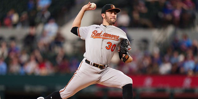 Grayson Rodriguez #30 of the Baltimore Orioles throws a pitch during his Major League debut against the Texas Rangers at Globe Life Field on April 5, 2023, in Arlington, Texas.