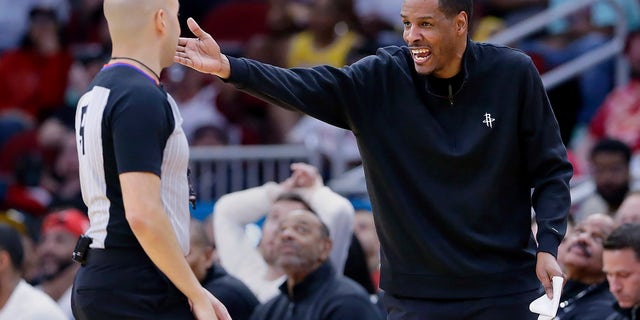 Houston Rockets head coach Stephen Silas, right, argues a foul call with referee Aaron Smith, left, during the second half of an NBA basketball game against the Los Angeles Lakers, Sunday, April 2, 2023, in Houston.