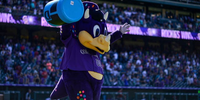 Colorado Rockies mascot Dinger holds an empty Powerade bucket after a win against the Arizona Diamondbacks at Coors Field on Aug. 14, 2019, in Denver.