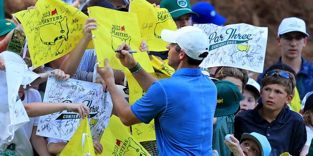 Rory McIlroy of Northern Ireland signs autographs after competing in the par 3 competition prior to the 2023 Masters Tournament at Augusta National Golf Club April 5, 2023, in Augusta, Ga. 