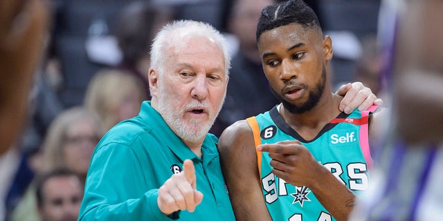 San Antonio Spurs head coach Gregg Popovich counsels guard Blake Wesley (14) during the first quarter of an NBA basketball game against the Sacramento Kings in Sacramento, Calif., Sunday, April 2, 2023.