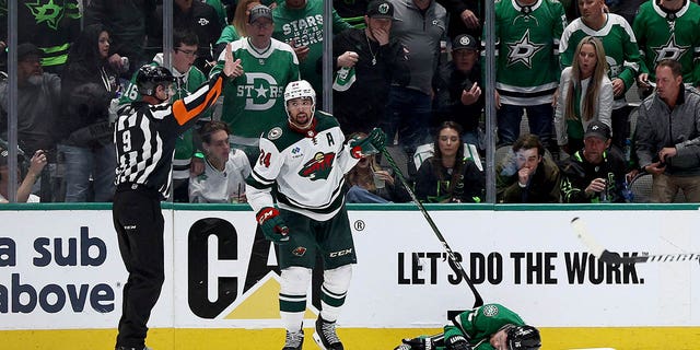 Joe Pavelski, #16 of the Dallas Stars, lies on the ice after a hit from Matt Dumba, #24 of the Minnesota Wild, in the second period in Game One of the First Round of the 2023 Stanley Cup Playoffs at American Airlines Center on April 17, 2023 in Dallas.