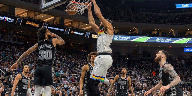 Minnesota Timberwolves center Rudy Gobert dunks over San Antonio Spurs forward Julian Champagnie, Saturday, April 8, 2023, in Austin, Texas.