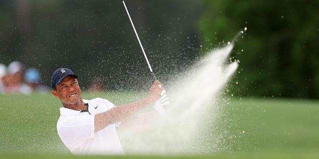 Tiger Woods plays a shot from a bunker during the first round of the Masters Tournament at Augusta National Golf Club on April 6, 2023.