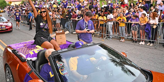 LSU forward Angel Reese waves to fans as the women's NCAA college national champion basketball team paraded across campus in Baton Rouge, Louisiana, Wednesday, April 5, 2023.