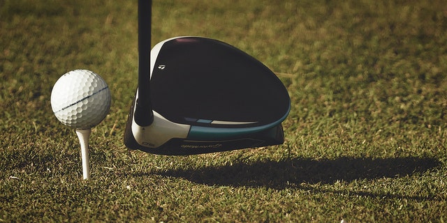 A general view of a golf ball on a tee with a driver