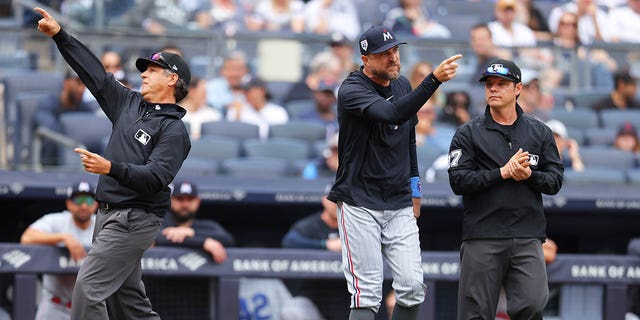 Umpire James Hoye, #92, ejects Rocco Baldelli, #5 of the Minnesota Twins, in the fourth inning against the New York Yankees at Yankee Stadium on April 15, 2023, in Bronx, New York. All players are wearing the #42 in honor of Jackie Robinson Day. 