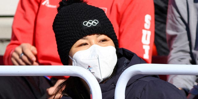 China's Peng Shuai, wearing a face mask, watches an event.